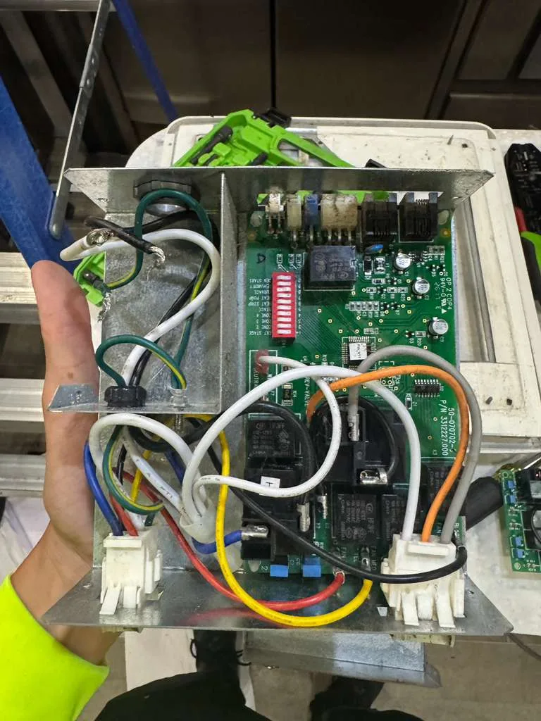 Close-up of RV electrical component replacement showing relay and contactor assembly inside an automatic transfer switch