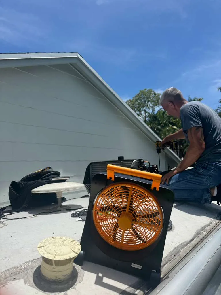 Triton RV technician performing a roof inspection on a used RV before purchase